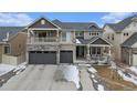 Beautiful two-story home with stone accents, a covered porch and two-car garage at 4981 Liverpool St, Denver, CO 80249