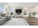 Elegant living room with a fireplace, TV and hardwood floors, perfect for entertaining at 4981 Liverpool St, Denver, CO 80249