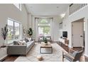 Bright living room with soaring ceilings, large windows, and modern furnishings exudes contemporary comfort at 11029 Grouse Ct, Parker, CO 80134