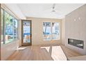 Bright room with large windows, modern fireplace, and wood floors provides an open and airy feel to the home at 2323 S High St, Denver, CO 80210