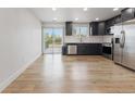 Modern kitchen with stainless steel appliances, sleek countertops, and access to the outdoor patio at 18396 E Mexico Pl, Aurora, CO 80017