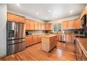 Well-equipped kitchen with stainless steel appliances, granite countertops, and hardwood floors at 1155 S Balsam St, Lakewood, CO 80232