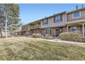 A row of townhouses showcases unique facades, bay windows, and well-maintained lawns at 8862 E Amherst Dr # D, Denver, CO 80231