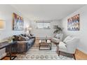 Inviting living room with hardwood floors, a cozy seating area, and natural light, ideal for comfortable living and relaxation at 3047 W 47Th Ave # 112, Denver, CO 80211