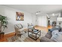 Bright living room with hardwood floors, stylish furnishings, and a seamless flow to the dining area, creating a welcoming space at 3047 W 47Th Ave # 112, Denver, CO 80211