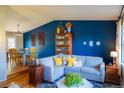 Comfortable living room with a cozy sectional sofa, bookshelf, and stylish accents at 7328 S Kit Carson St, Centennial, CO 80122