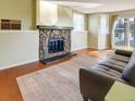 Inviting living room with a stone fireplace and sliding doors to the outside at 17505 E Mansfield Ave # 1411L, Aurora, CO 80013