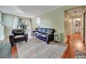 Bright living room with hardwood floors, comfortable seating, and access to a patio area at 17505 E Mansfield Ave # 1411L, Aurora, CO 80013