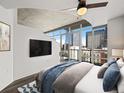 Serene bedroom with concrete ceilings, city views, and a comfortable bed for relaxation at 891 14Th St # 2314, Denver, CO 80202