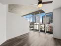 Light-filled bedroom with city views through expansive windows and hardwood-style floors at 891 14Th St # 2314, Denver, CO 80202