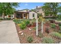 Landscaped front yard with charming curb appeal and walkway at 113 S 4Th Ave, Brighton, CO 80601