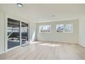 Bright, sun-filled room with a sliding door to the outside patio and light wood flooring at 5050 Steele St, Denver, CO 80216