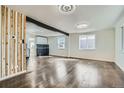 Bright open living space featuring hardwood floors, modern lighting, and a stylish beam accent at 5050 Steele St, Denver, CO 80216