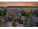 Aerial view of a charming neighborhood with lush greenery and views of the mountains at 10866 W Half Moon Pass, Littleton, CO 80127