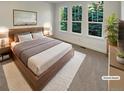 Serene bedroom with a modern wooden bed frame, soft carpet, three windows and a calming decor at 24955 E Roxbury Pl, Aurora, CO 80016