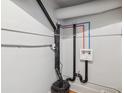 Utility connections, including red and blue pipes, are visible in the basement at 1581 N Ogden St, Denver, CO 80218