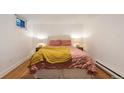 Comfortable bedroom with wood floors and pink bedding at 1581 N Ogden St, Denver, CO 80218