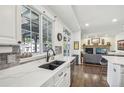 This gourmet kitchen is complete with marble countertops, dark hardware, and stainless steel appliances at 7513 Simms Ct, Arvada, CO 80005