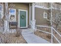 Welcoming front entrance with a decorative wreath, stone accents, and a well-manicured landscape at 14700 E 104Th Ave # 1404, Commerce City, CO 80022
