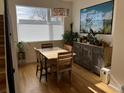 Sunlit dining room features a wood table set, hardwood floors, and a large picturesque window at 1284 Osceola St, Denver, CO 80204