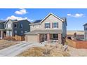 Charming two-story home features solar panels, a front porch, and a two car garage at 7967 E 139Th Pl, Thornton, CO 80602
