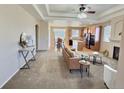 Open floor plan with living room flowing into kitchen and dining area, featuring modern finishes and ample natural light at 6321 Spring Gulch St, Frederick, CO 80516
