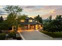 Beautiful two-story home featuring stone accents, a three-car garage, and professional landscaping at 5322 Devils Head Cir, Golden, CO 80403