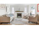 Bright living room boasts hardwood floors, fireplace, and light, neutral decor at 1220 Magnolia St, Denver, CO 80220
