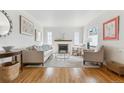 Inviting living room features a fireplace, hardwood floors, and neutral decor at 1220 Magnolia St, Denver, CO 80220