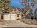 Charming home with a three car garage and manicured front yard at 6141 W Evans Pl, Lakewood, CO 80227