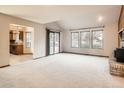 Spacious living room with a fireplace and access to the backyard at 6141 W Evans Pl, Lakewood, CO 80227