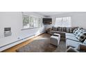 Spacious living room featuring a cozy sectional sofa and hardwood floors at 2095 Newland St, Edgewater, CO 80214