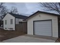 Detached garage with a spacious driveway at 1690 S Umatilla St, Denver, CO 80223