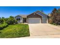 Charming single-Gathering home featuring a well-manicured lawn and a convenient three-car garage at 3859 Rawhide Cir, Castle Rock, CO 80104