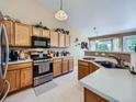 Well-lit kitchen showcasing wood cabinets, stainless steel appliances, and ample counter space at 3859 Rawhide Cir, Castle Rock, CO 80104