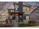 Stylish two-story home featuring a modern design with a covered front porch and manicured landscaping at 9791 Dunning Cir, Highlands Ranch, CO 80126