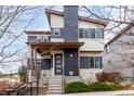 Stylish two-story home featuring a modern design with a covered front porch and manicured landscaping at 9791 Dunning Cir, Highlands Ranch, CO 80126