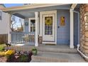Inviting front porch with a charming yellow wreath and cozy seating area at 11753 Elizabeth Cir, Thornton, CO 80233
