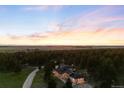 A dramatic sunset over the home with acreage in the Colorado mountains at 30886 County Road 17/21, Elizabeth, CO 80107