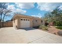 Attached one-car garage and extended driveway offer convenience in this brick home's exterior at 5540 E Jewell Ave, Denver, CO 80222