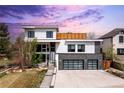 Modern two-story home featuring a two-car garage, landscaped front yard, and clean architectural lines at 942 S Fulton St, Denver, CO 80247