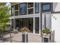 Inviting front porch with modern railing and decorative flowerpots at 942 S Fulton St, Aurora, CO 80247