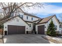 Beautiful exterior view of a two-story home featuring a spacious driveway and manicured front yard at 2932 Newbury Ct, Highlands Ranch, CO 80126