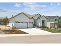 Charming home featuring a three-car garage, well-maintained lawn, and welcoming curb appeal at 13805 Emerald Lake St, Parker, CO 80138