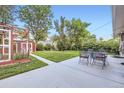 Spacious backyard with a concrete patio, outdoor seating, and a small shed at 2982 S Vrain St, Denver, CO 80236