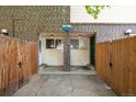 Inviting entrance with a fenced-in patio, brick accents, and updated doors at 8023 Wolff St # C, Westminster, CO 80031