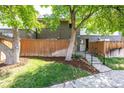 Well-maintained front yard with lush greenery and a charming brick townhouse facade at 8023 Wolff St # C, Westminster, CO 80031