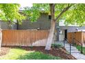 Charming townhouse featuring a brick facade, fenced-in front yard, and landscaped entrance at 8023 Wolff St # C, Westminster, CO 80031
