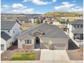 Beautiful home with a three-car garage, stone accents, and a spacious yard, surrounded by stunning views at 863 Edenborn Pl, Castle Rock, CO 80104