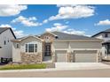 Beautiful, well-maintained home showcasing a two-car garage, stone accents, and meticulous landscaping at 863 Edenborn Pl, Castle Rock, CO 80104